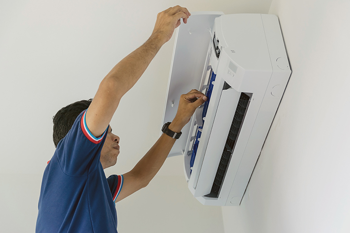 air-conditioner-repairers-blue-uniform-are-checking-repair-air-hanging-wall